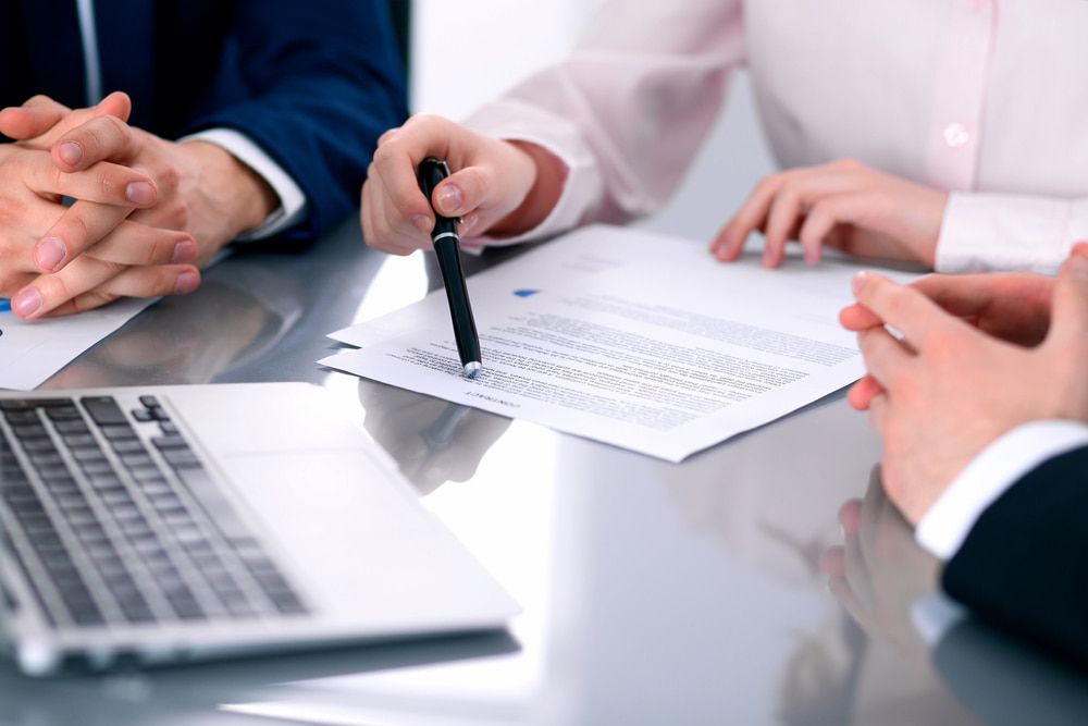 Three People at a Table Reviewing Documents — Curtis Strata in Casino, NSW