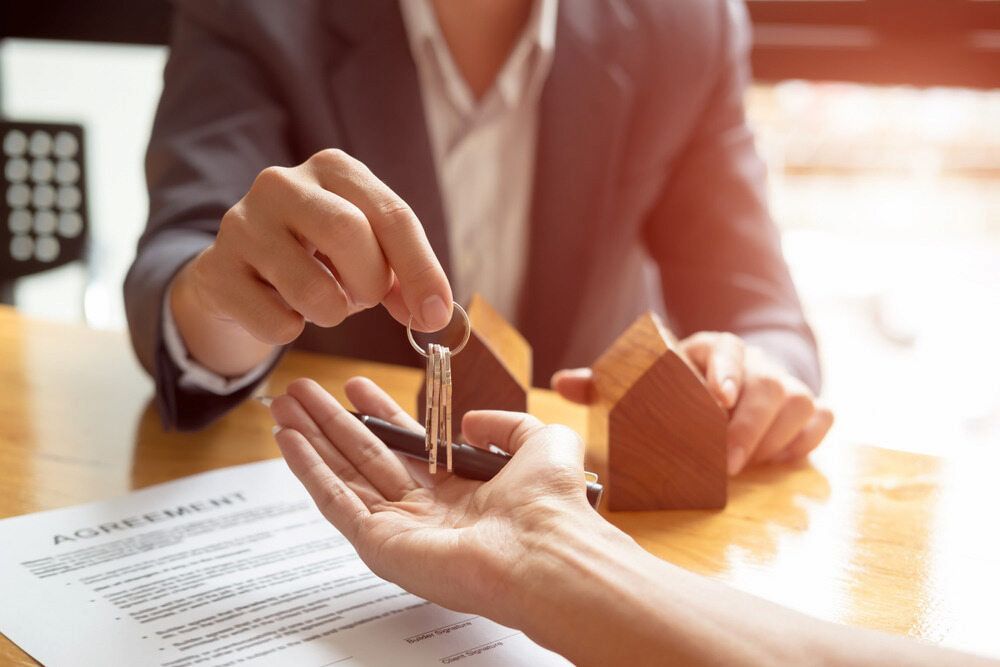 Handing Over Keys to a Person, Wooden House Models — Curtis Strata in Yamba, NSW