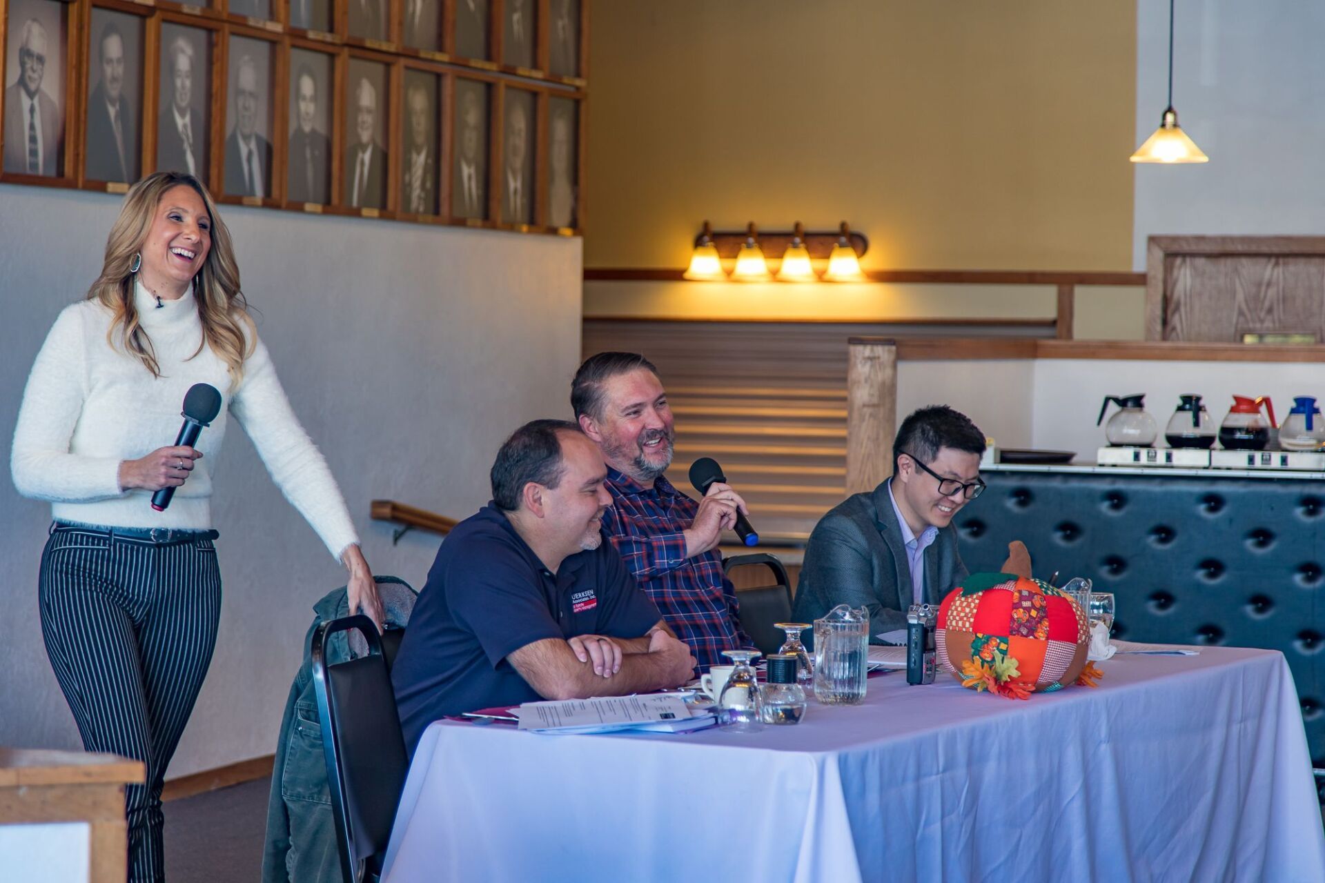 Picture of Dawn smiling with a panel of experts at RMPG