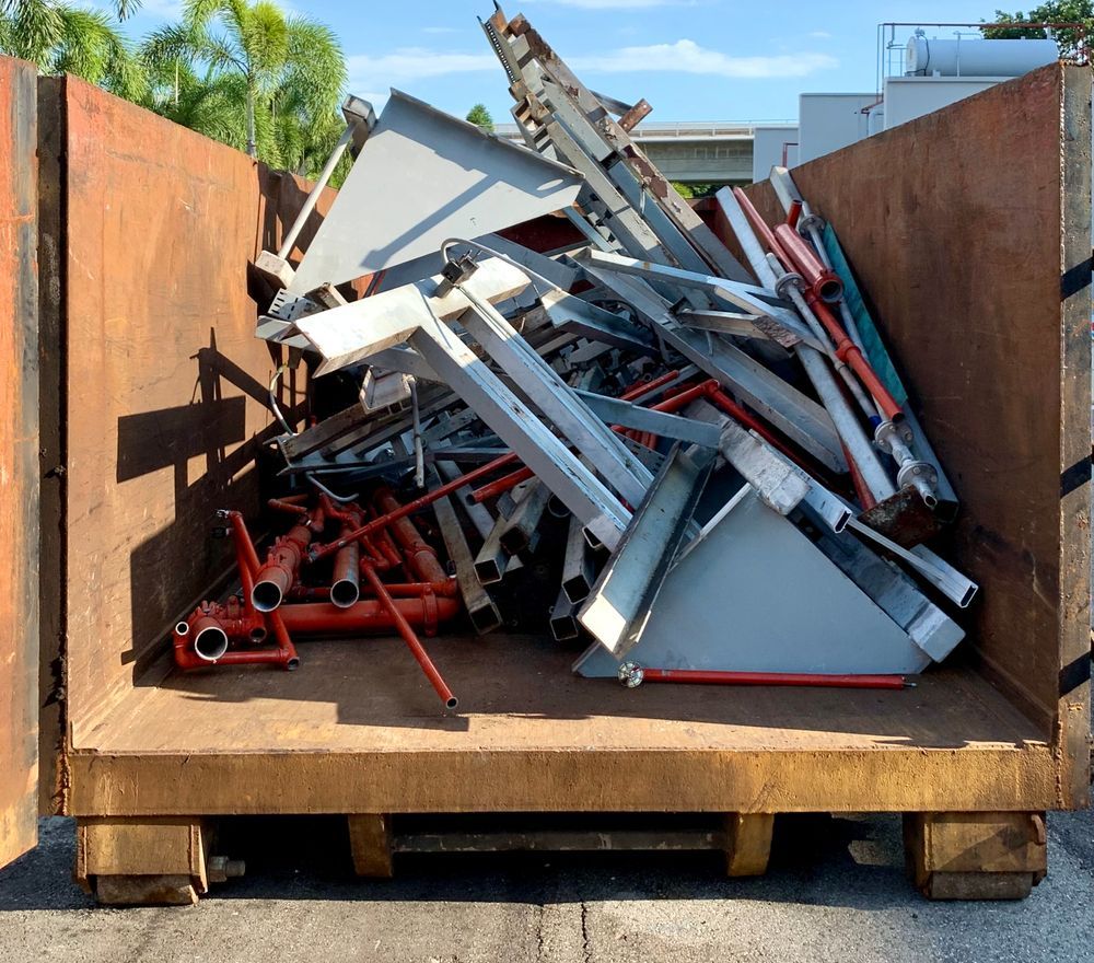 Metal Scrap Piled Inside a Large Rusty Container Outdoors — Independent Scrap Metal Pty Ltd in Murwillumbah, NSW