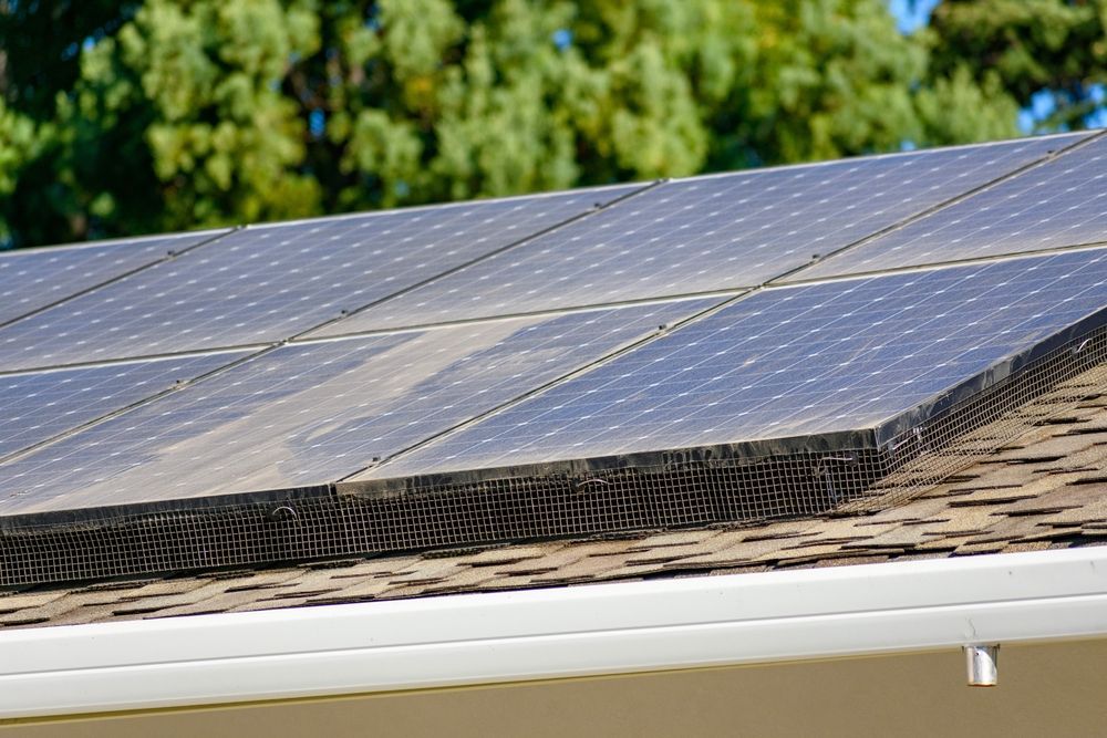 Solar Panels on a Brown Shingle Roof, With a White Gutter — Independent Scrap Metal Pty Ltd in South Lismore, NSW