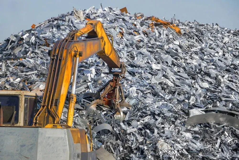 Yellow Excavator Sorting Scrap Metal at a Recycling Center — Independent Scrap Metal Pty Ltd in Ballina, NSW
