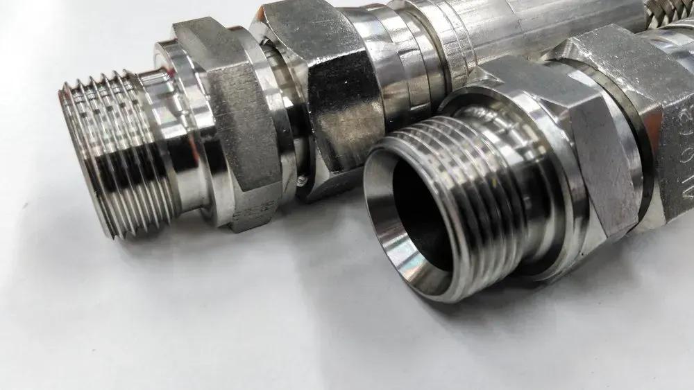 Two Shiny, Metal Fittings With Threaded Ends — Independent Scrap Metal Pty Ltd in Yamba, NSW
