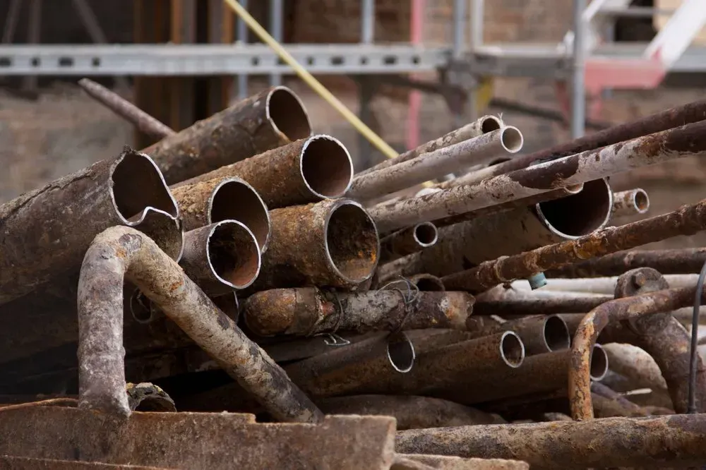 Pile of Rusty Metal Pipes and Rods; Construction Site — Independent Scrap Metal Pty Ltd in Clarence Valley, NSW