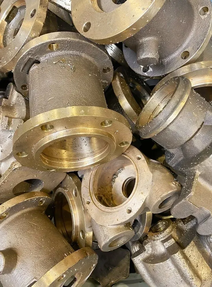 Pile of Bronze-coloured Industrial Pipe Fittings — Independent Scrap Metal Pty Ltd in South Lismore, NSW