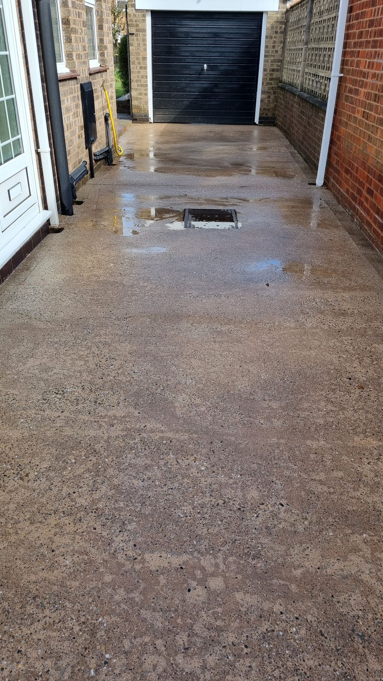 A concrete driveway after a professional driveway clean.