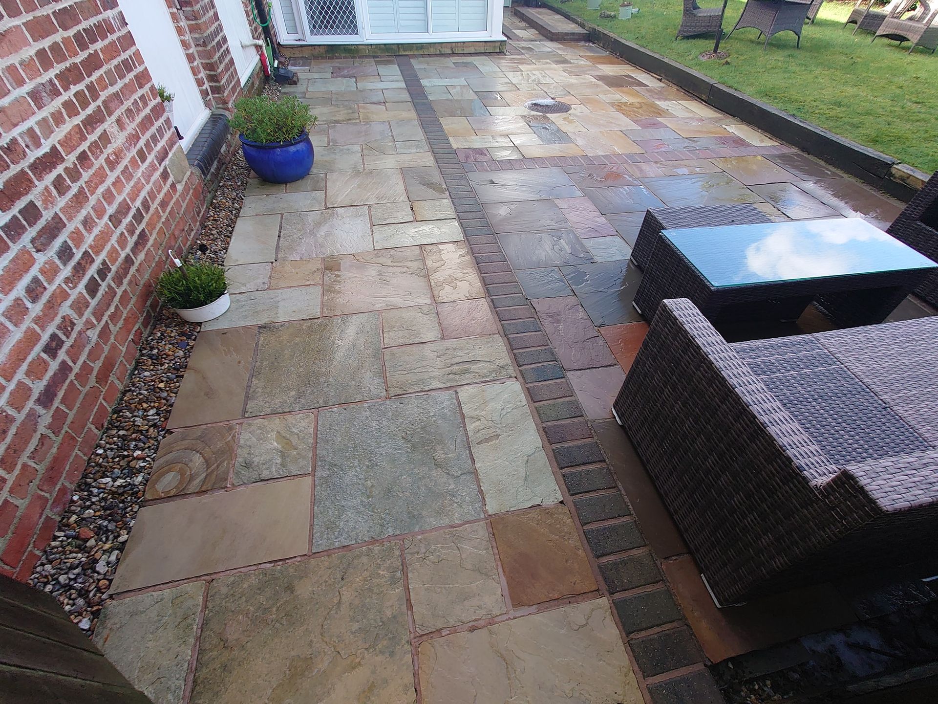 Indian Sandstone patio that is dull and dirty before being pressure washed.