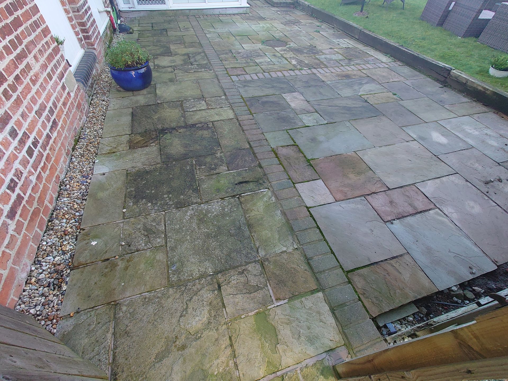 Indian Sandstone patio that is dull and dirty before being pressure washed.