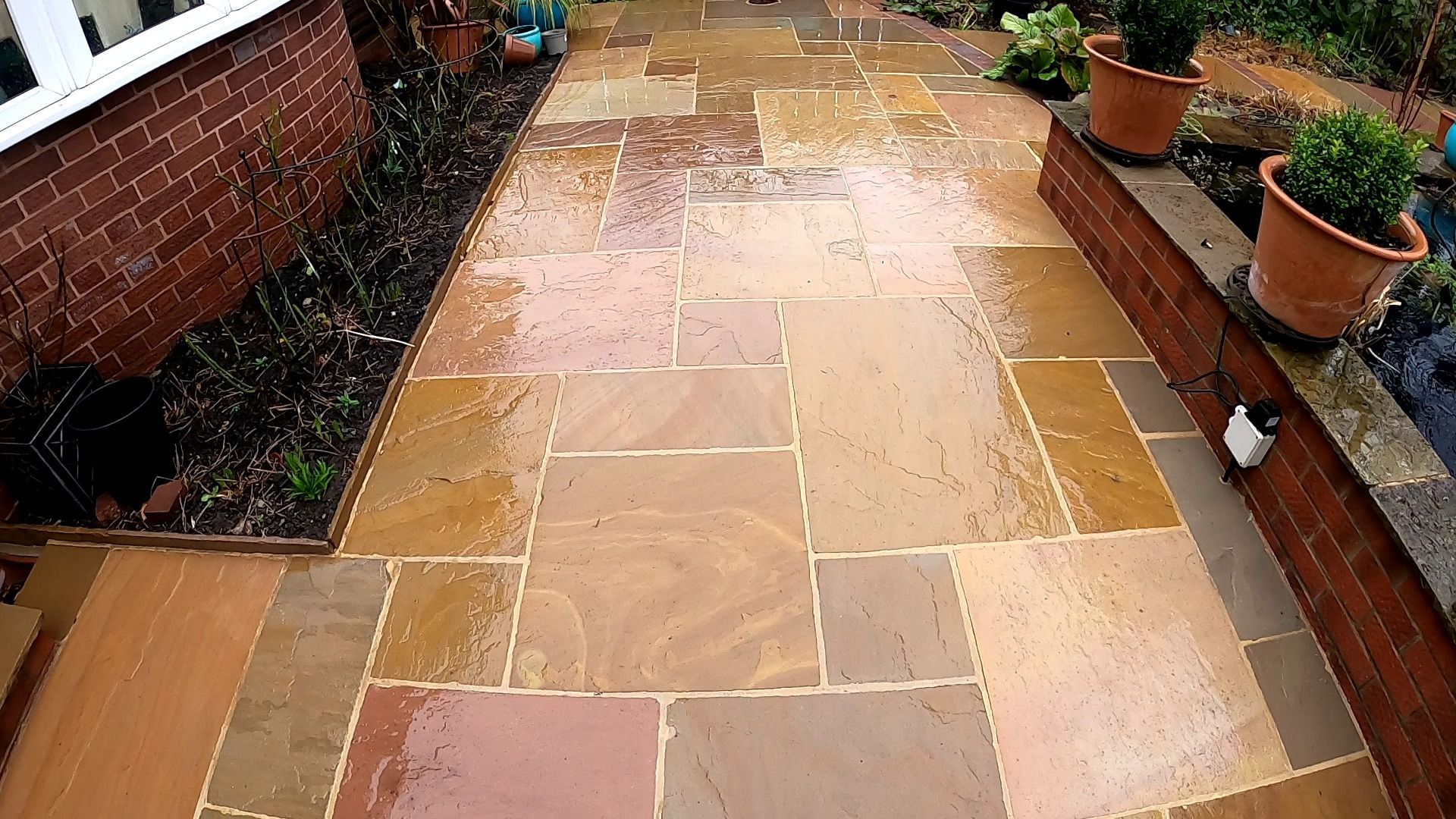 Indian Sandstone patio that is bright and clean after being pressure washed.