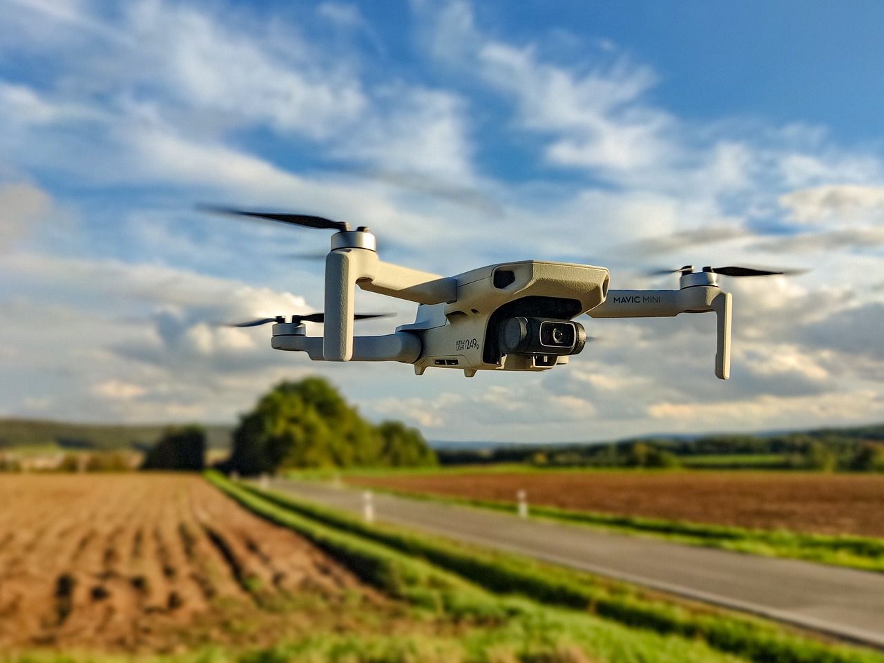 DJI Mini 249g Drone flying over farmland