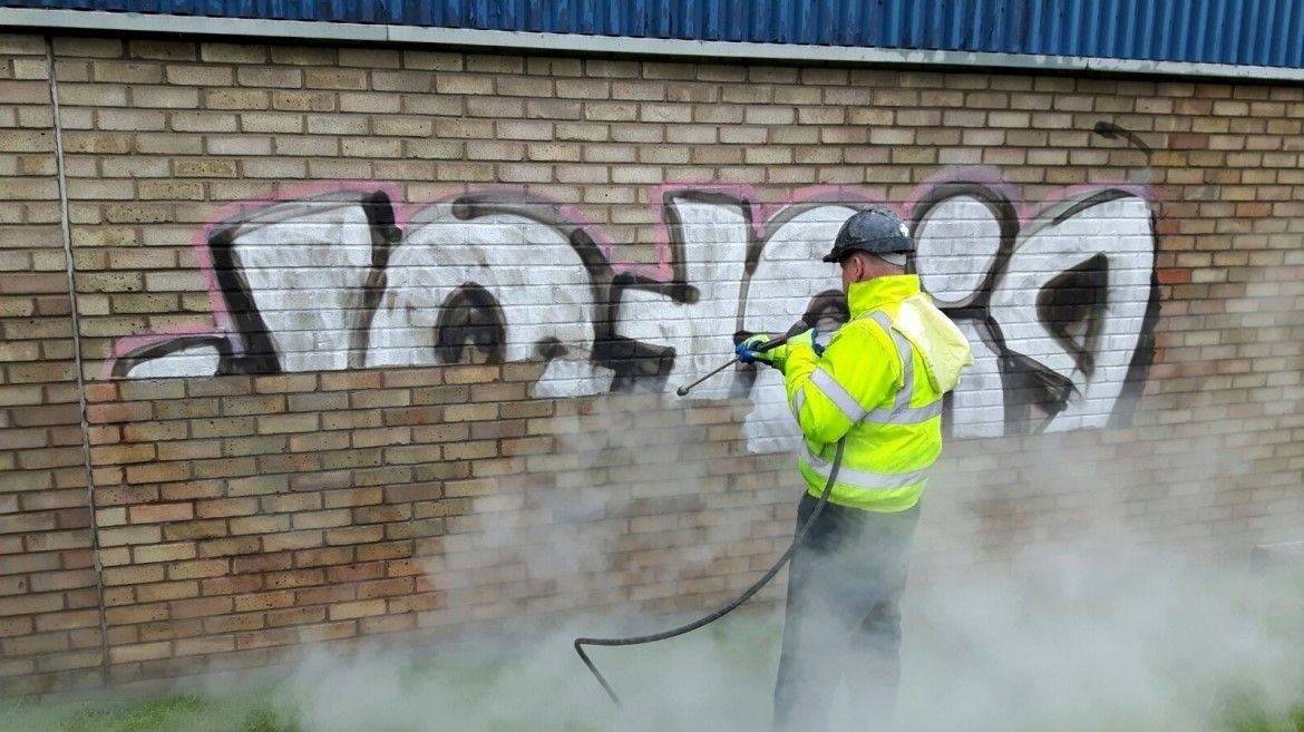 Graffiti being removed from wall with DOFF Steam Cleaning Machine