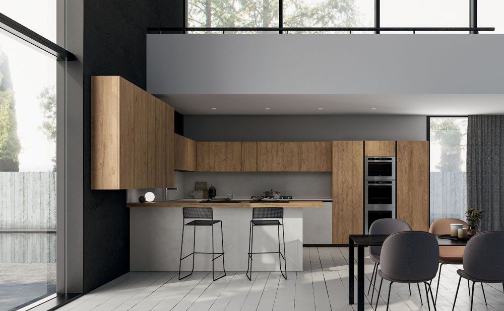Cucina moderna con mobili in legno, isola con sgabelli e zona pranzo.