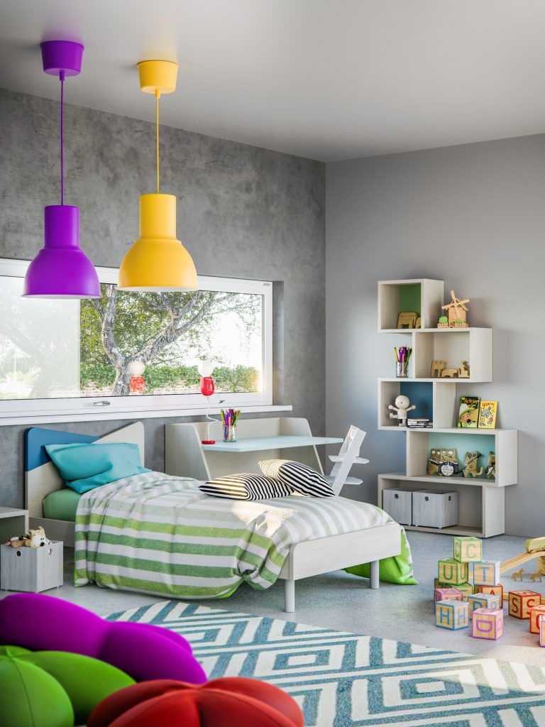 Cameretta per bambini con letto, scrivania, scaffali portaoggetti e lampade a sospensione colorate.
