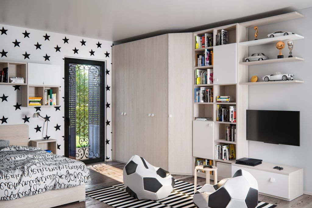 Camera da letto con carta da parati a stelle, mobili a muro in legno chiaro, letto e poltrone a sacco a forma di pallone da calcio.