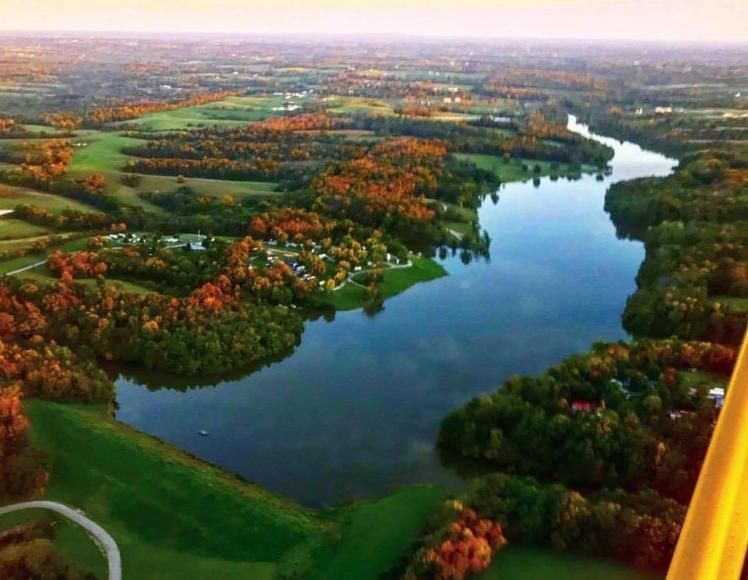 An aerial view of a lake surrounded by trees