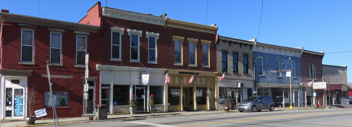 A row of brick buildings with a blue sky in the background