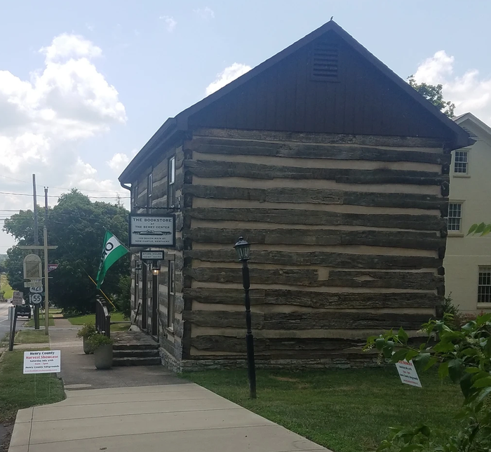 A log cabin with a sign that says ' a ' on it