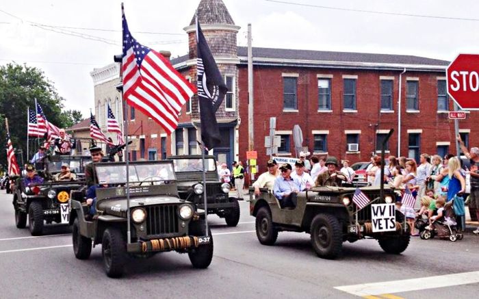 A stop sign is in the middle of a parade
