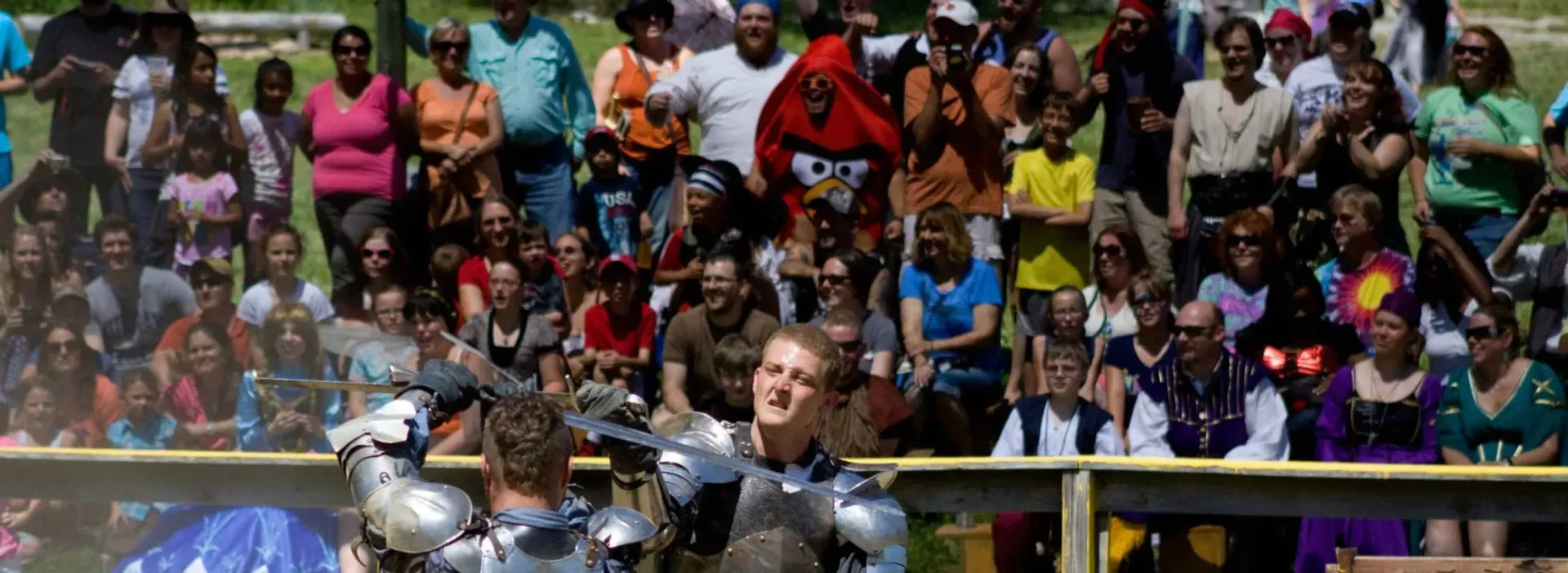A group of people are standing in front of a crowd.