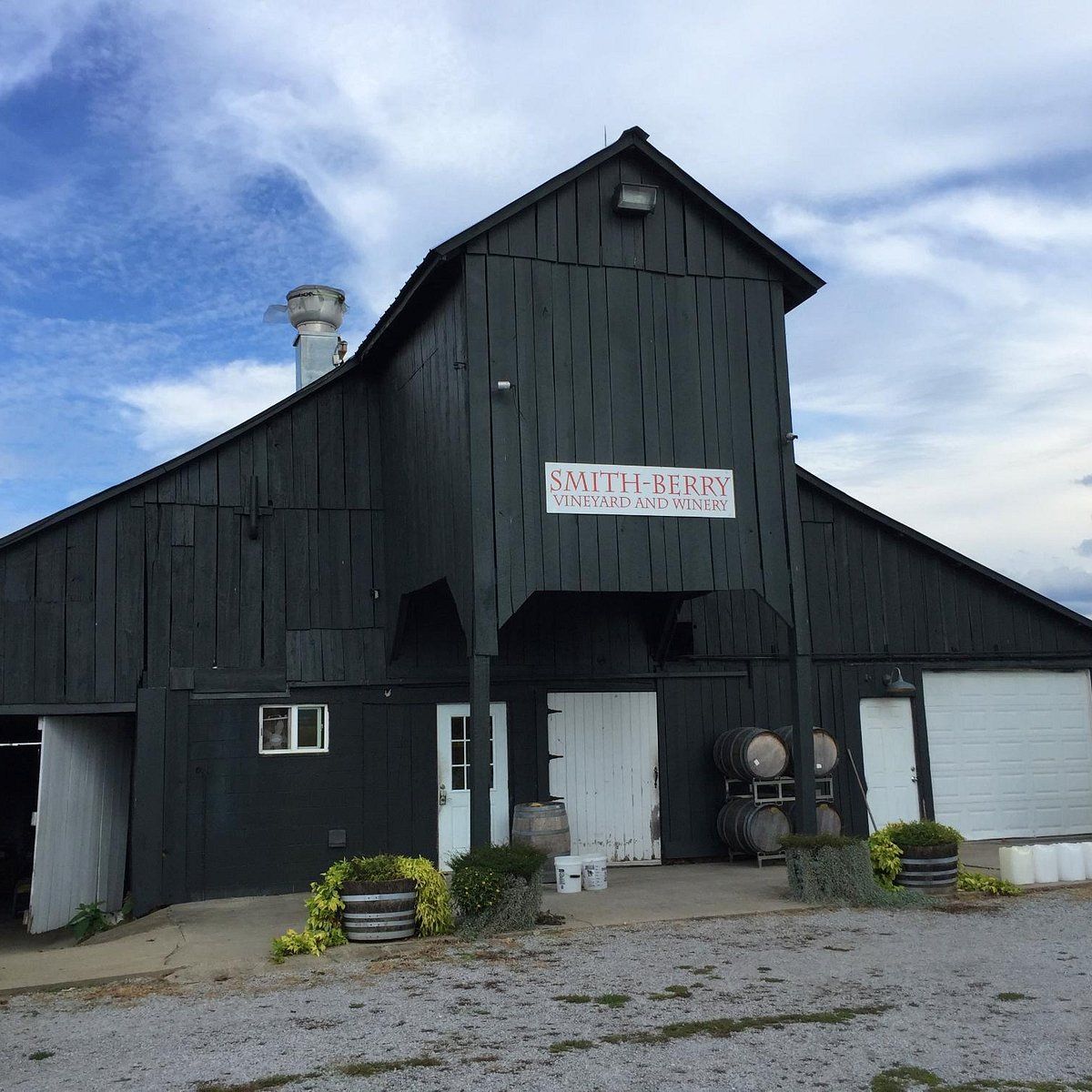 A large black barn with a sign that says south barn