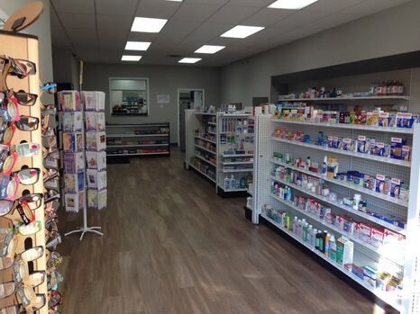 The inside of a pharmacy with shelves filled with lots of products.