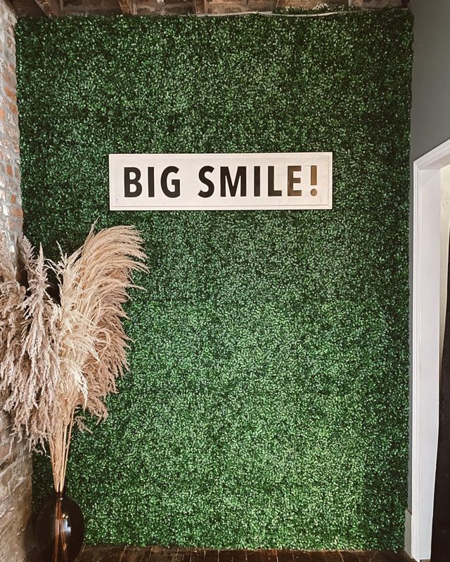There is a sign on the wall that says `` big smile ''.