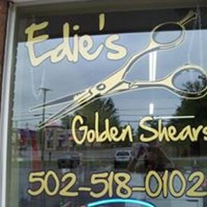 A sign in a window for edie 's golden shears