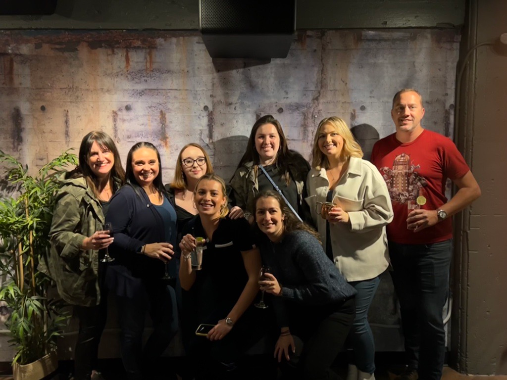 A group of people are posing for a picture in a room.