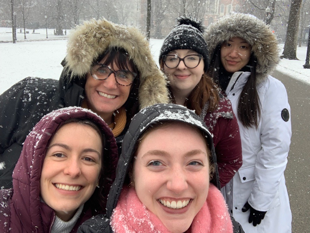 A group of women are posing for a picture in the snow.