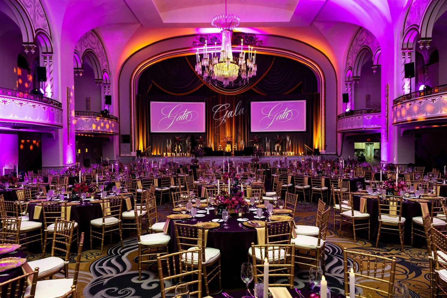 A large room with tables and chairs set up for a party