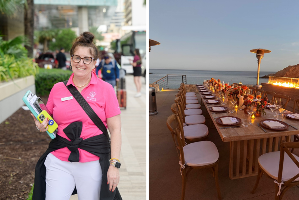 A woman in a pink shirt is standing next to a long table.
