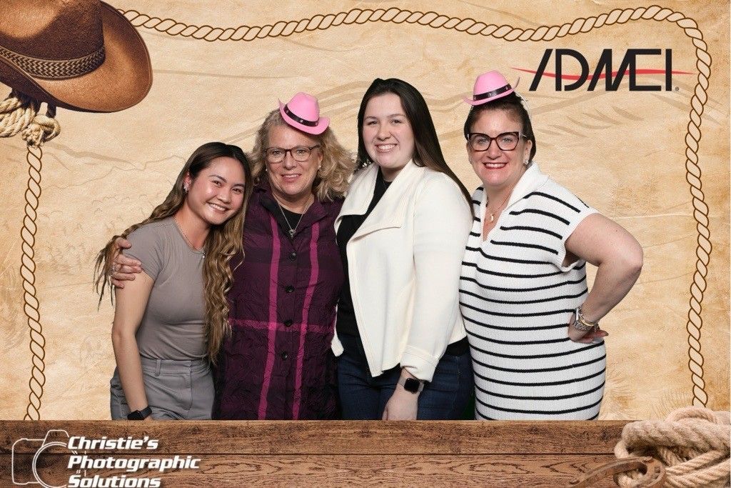 A group of women are posing for a picture in a photo booth.