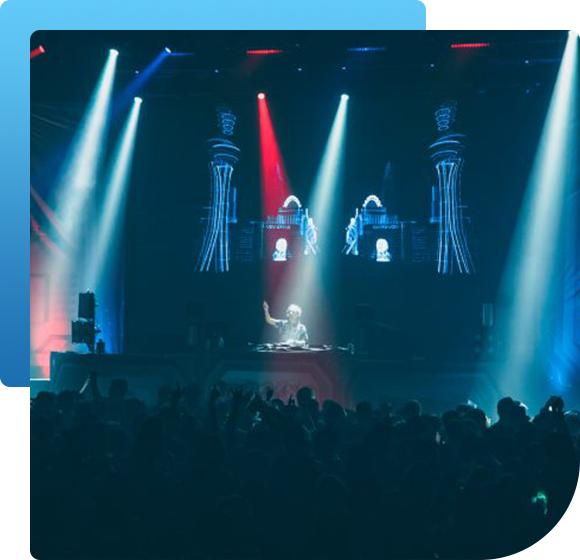 A dj is playing music in front of a crowd at a concert