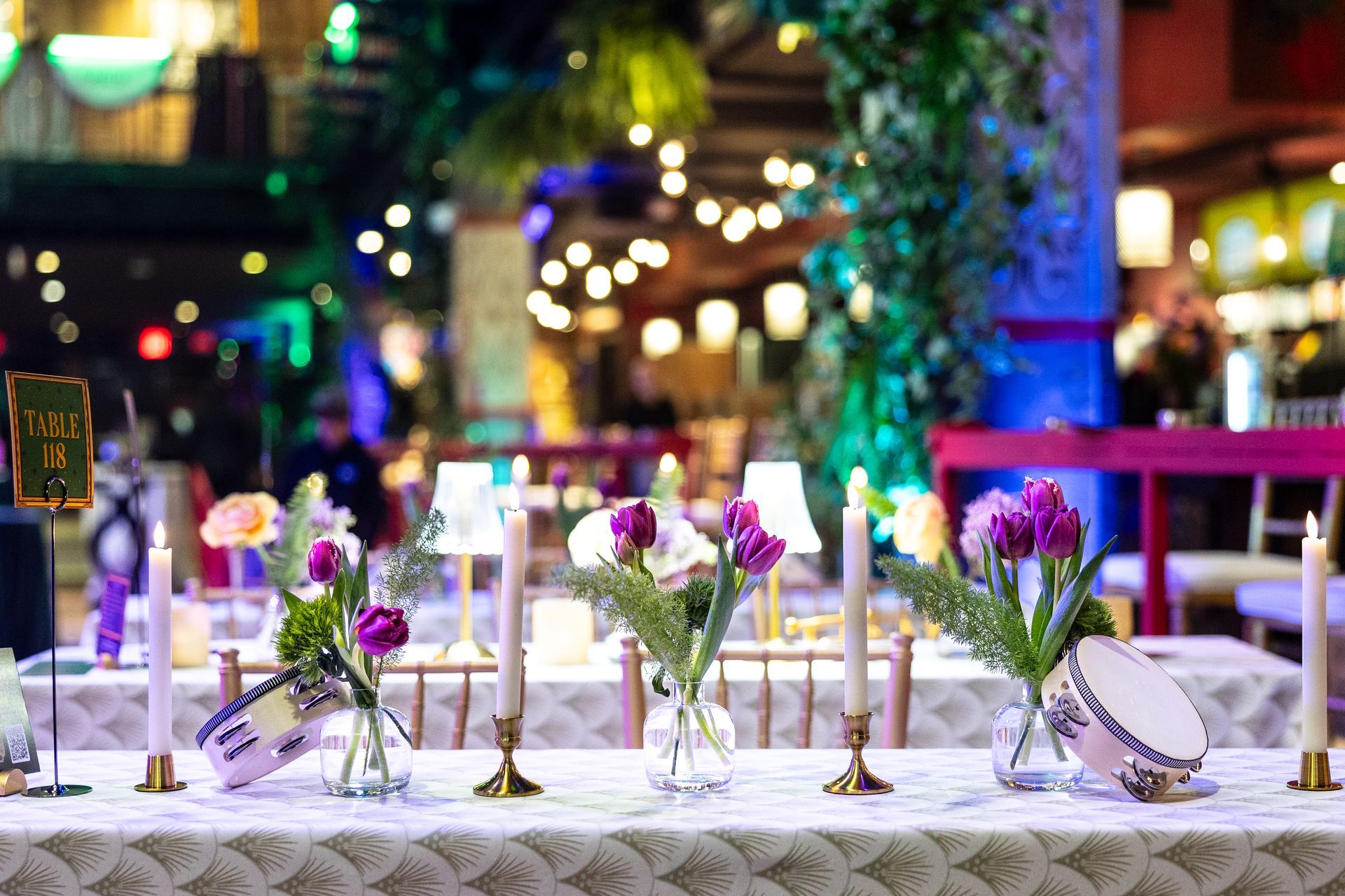 Festive table setting with flowers, candles, and decor, indoors.
