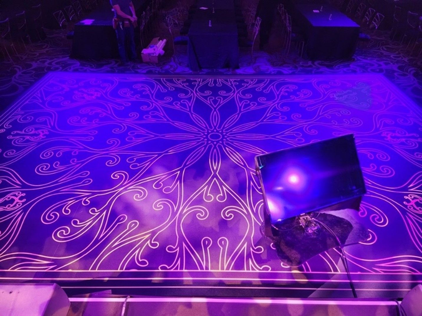 A stage with purple lights and a pattern on it
