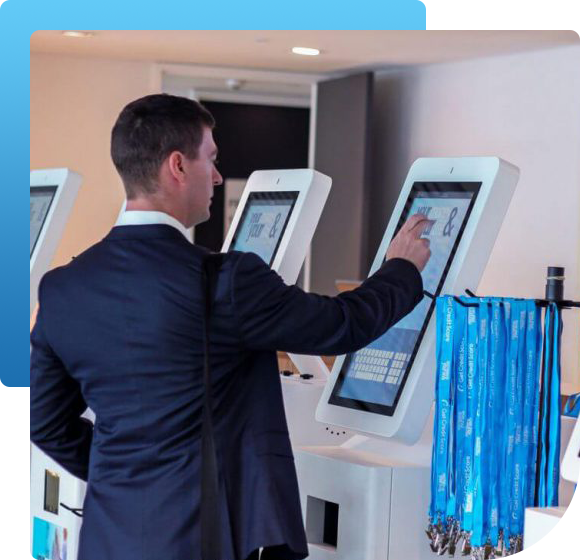 A man in a suit is using a touchscreen kiosk