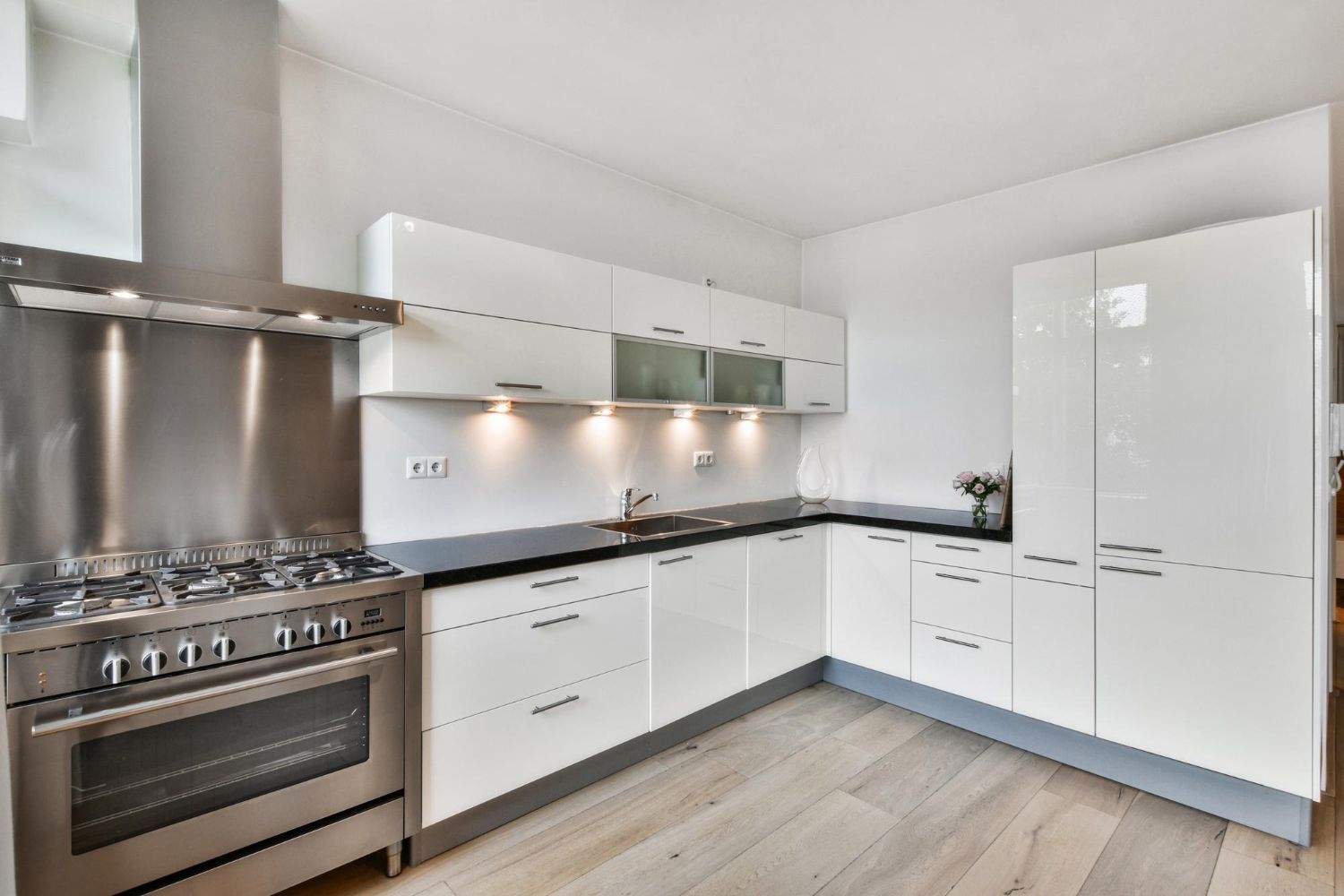 Modern kitchen with white glass splashback