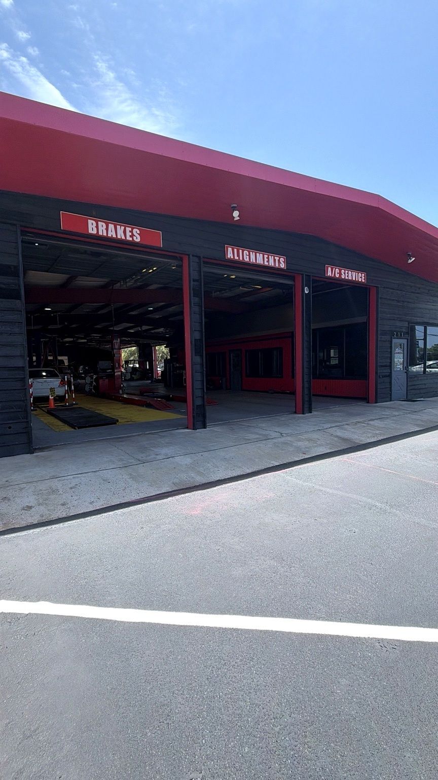 Auto Repair Shop Exterior With Open Service Bays | Coastal Autoxpress