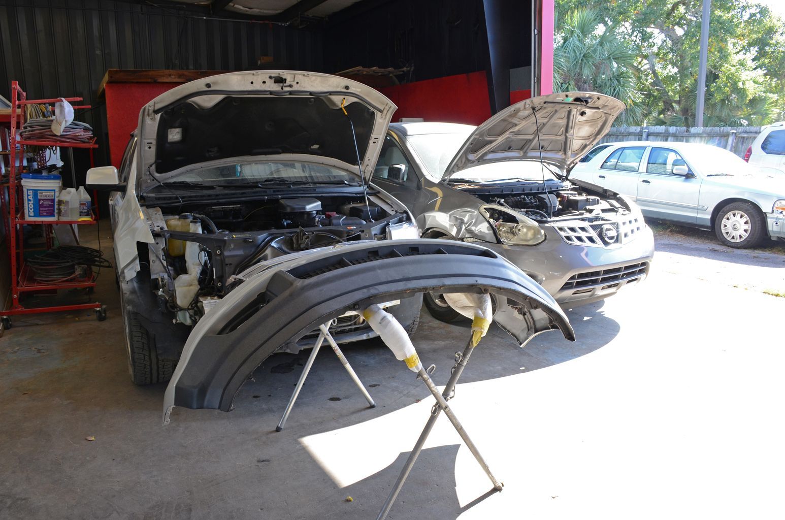 Vehicles Undergoing Professional Auto Repair Service | Coastal Autoxpress