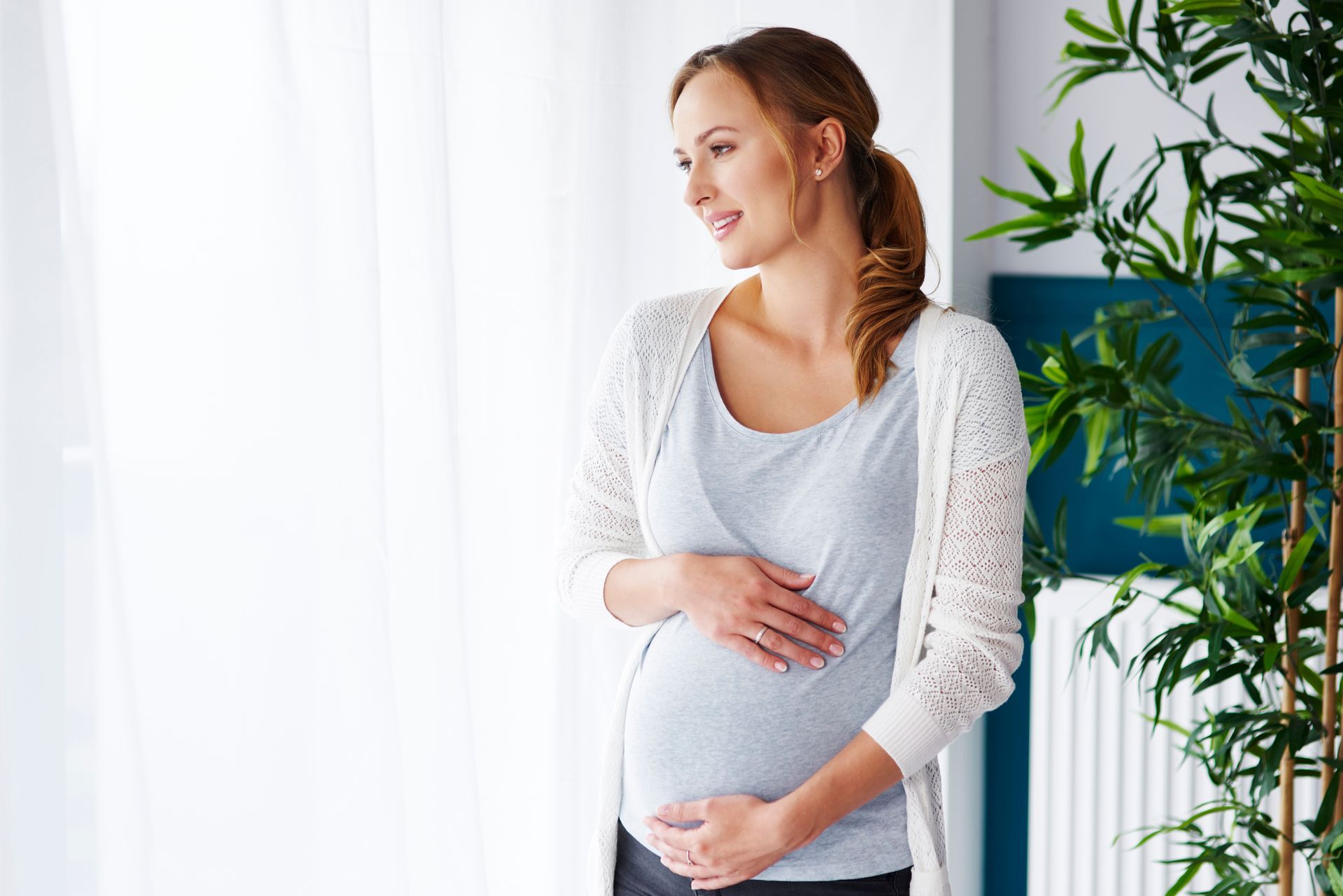 Pregnant woman cradling her belly