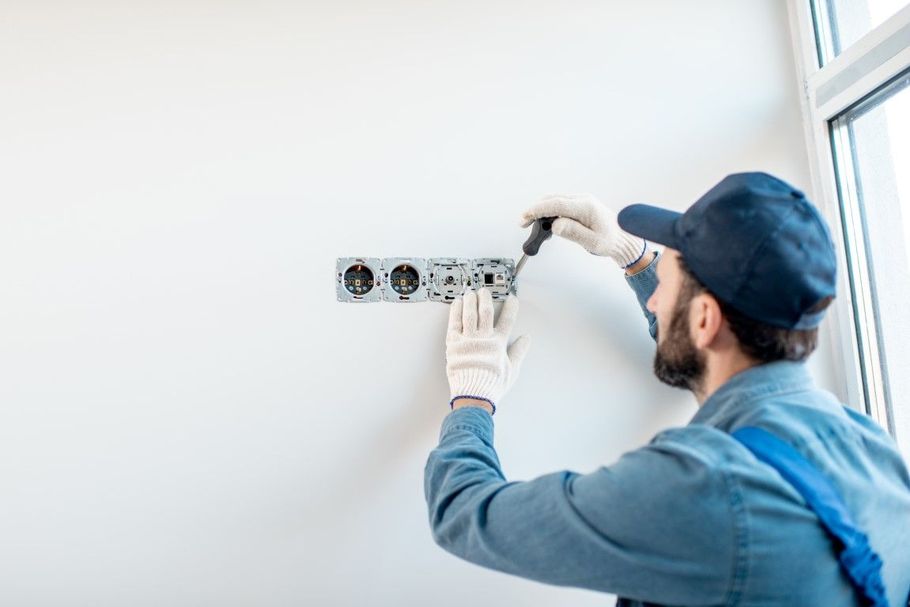 Electricians testing a breaker panel.