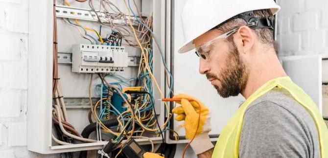 Electrician testing a circuit panel