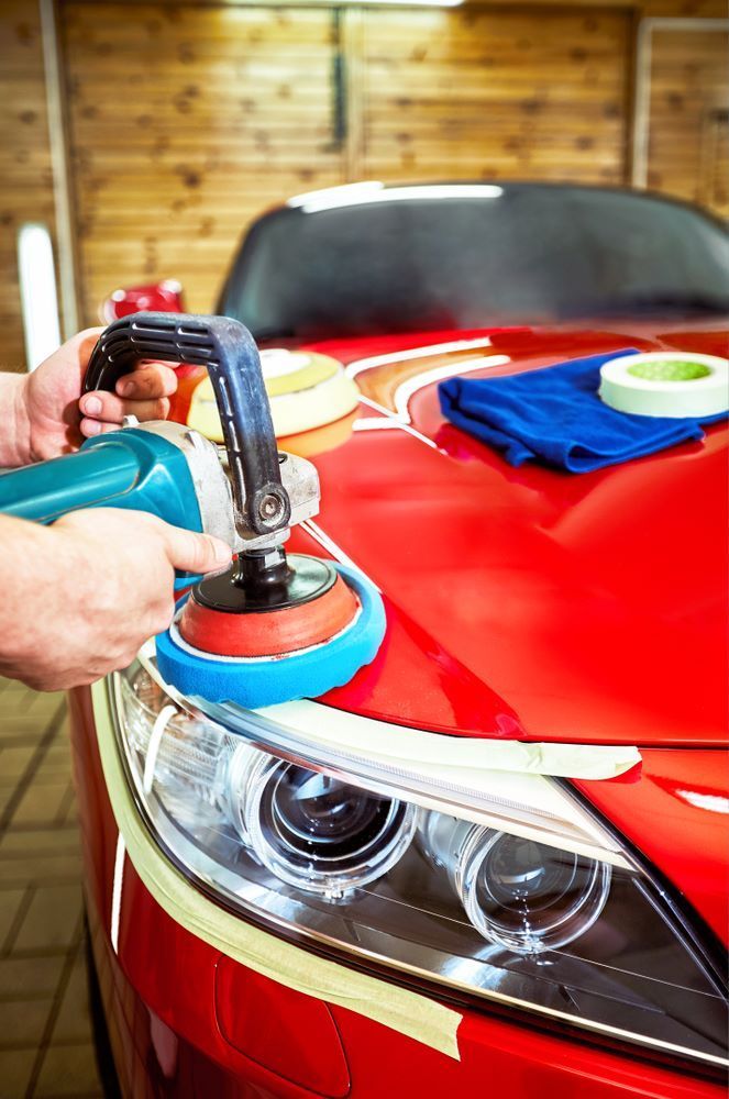 A Person Is Polishing a Red Car — Mahers Smash Repairs in Nundle, NSW