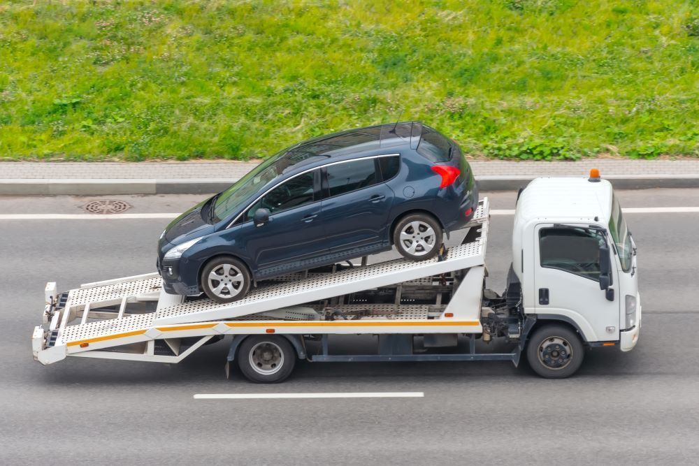 A Tow Truck Is Carrying a Car — Mahers Smash Repairs in Quirindi, NSW
