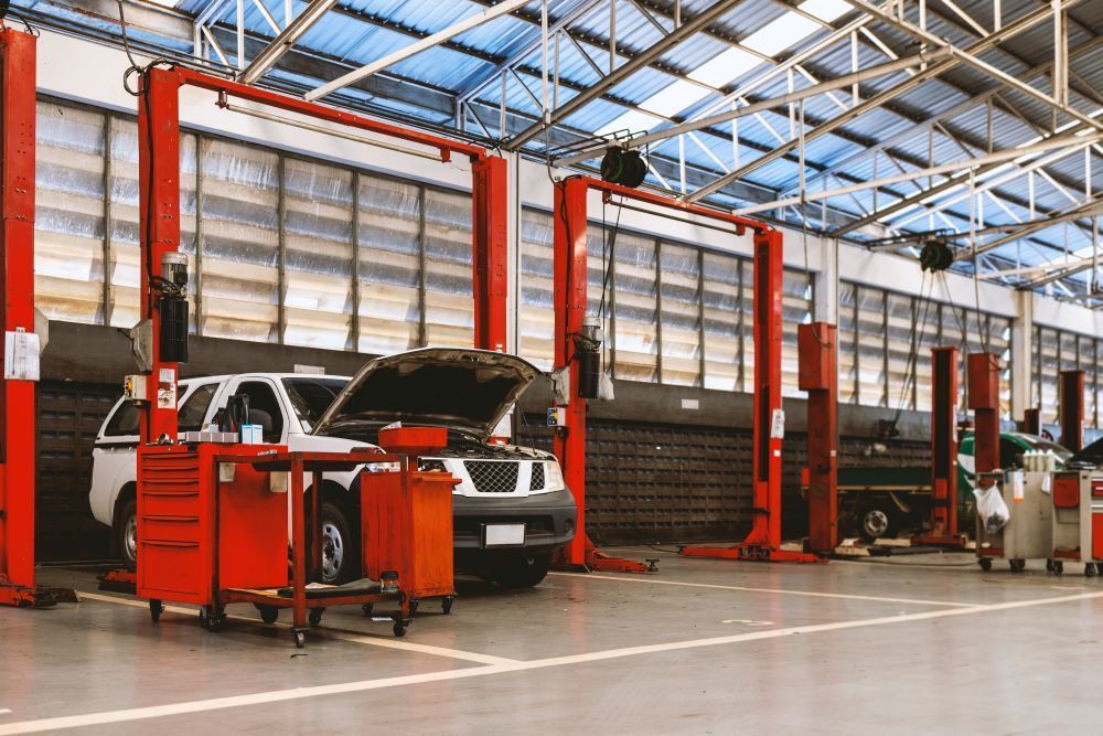 A Car Is Sitting on A Lift in A Garage — Mahers Smash Repairs in Werris Creek, NSW
