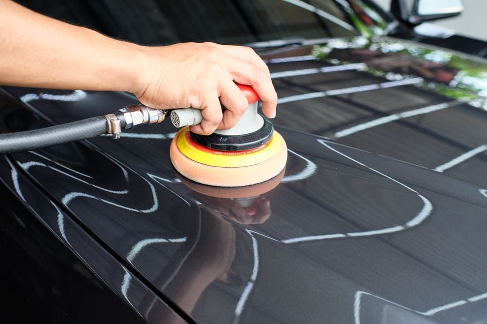 A Person Is Polishing The Hood Of A Car With An Air Sander — Mahers Smash Repairs in Nemingha, NSW