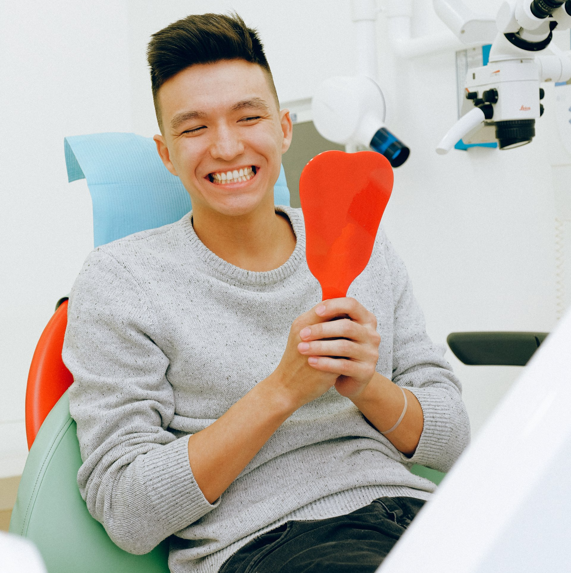 happy patient holding mirror