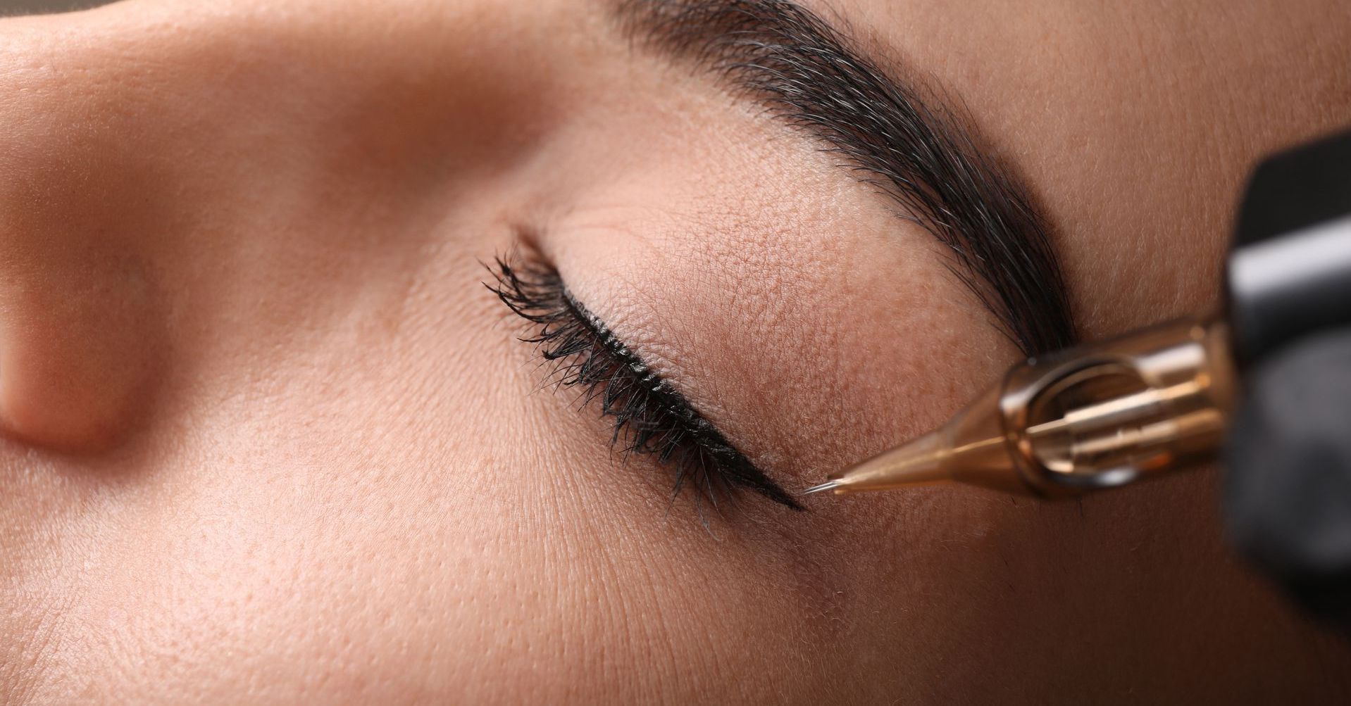 Close-up of a face with winged eyeliner and a soft smile