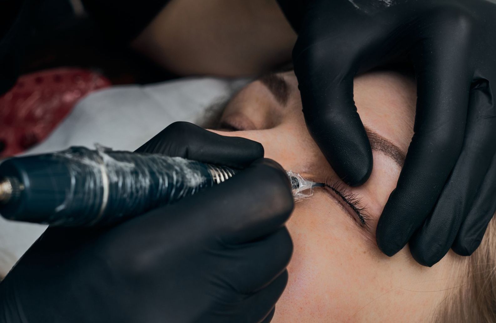 Close-up of a face with winged eyeliner and a soft smile