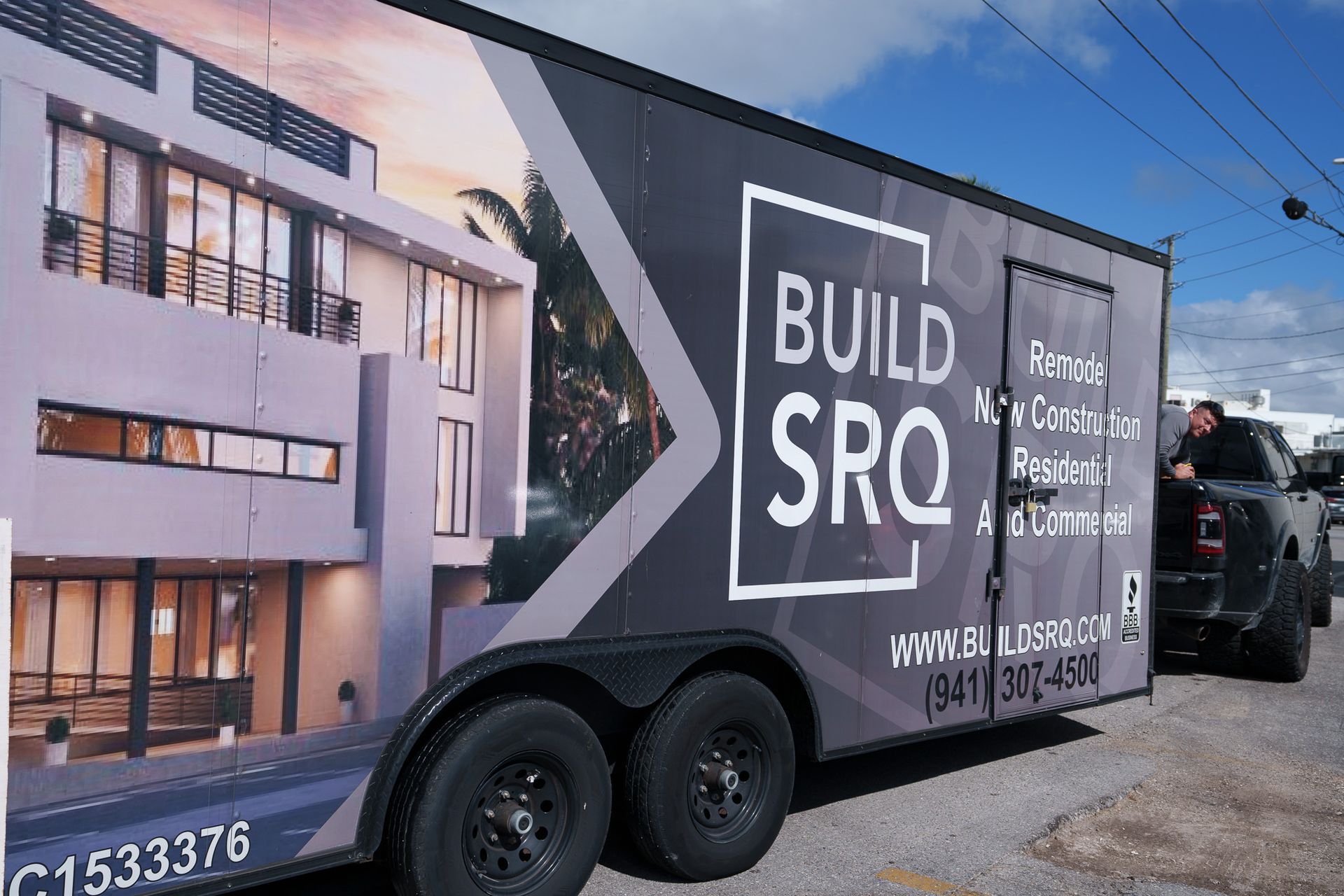 Build SRO truck with house rendering and “A Permanent Part of…” text parked outdoors.